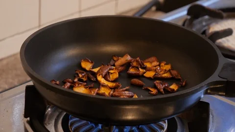 Close up of frying vegetable in black wok pan on gas in kitchen Stock Footage 146544597