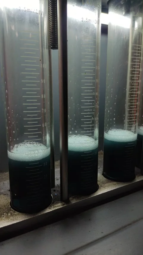 Close-up of fuel injectors spraying liquid into glass test tubes Stock Footage 332240635
