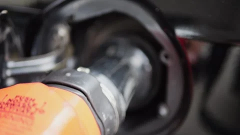 Close-up of fuel nozzle inserted into car tank at gas station. Stock Footage 316914165