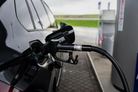 Close-up of fuel pump nozzle connected to car tank during gasoline refueling Stock Photos