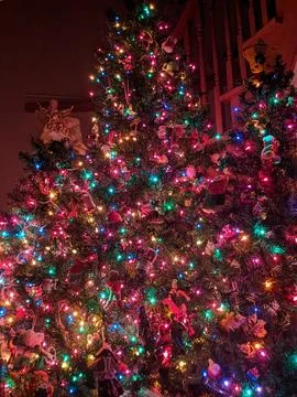 Close-up of a Full Christmas Tree Dense with Colorful Lights and Ornaments Фото