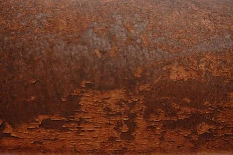 A close-up full frame abstract shot of peeling orange paint on a rusty metal Stock Photos