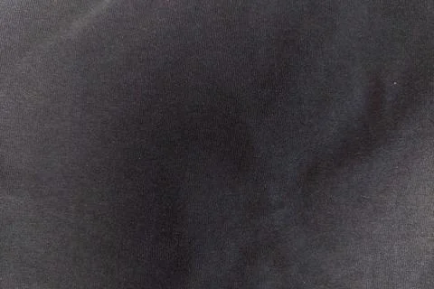 A close up full frame background shot of a textured charcoal black cotton f.. Stock Photos