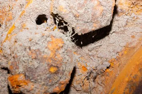 Close-up full frame of dry dirt on a rusty bumpy surface pattern. Stock Photos