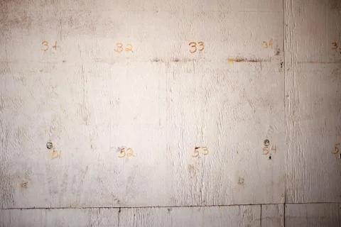 Close-up full frame of an old wall with numbers Foto stock