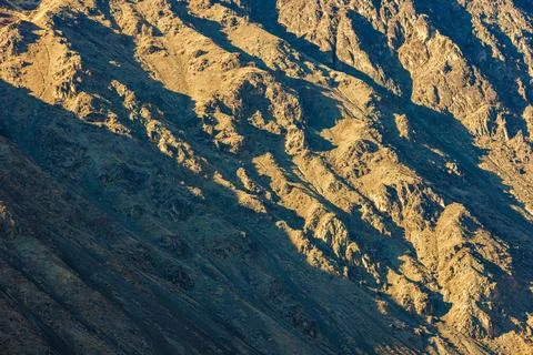 Close up full-frame view of a mountain side under direct evening sun light. Stock Photos