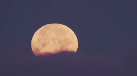 Close on full moon behind soft lavender clouds on arctic evening Stock Footage 65057894
