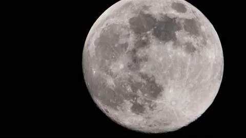 Close-up of a full moon wandering in the black night sky Stock Footage 234549899