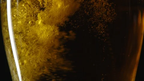 Close up full pint glass being filled with a splash of golden beer Stock Footage 93562016