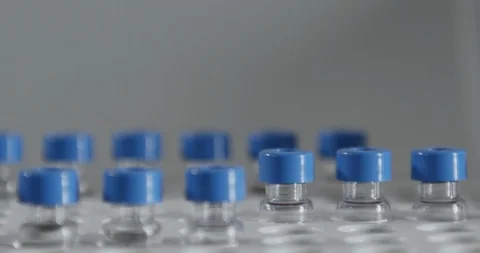 Close-up of fully automatic syringe filling different test tubes Stock Footage 104820795