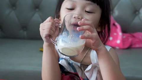 Close up fun portrait of cute asian girl showing white milk mustache.Isolated Stock Footage 126726274