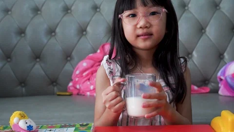 Close up fun portrait of cute asian girl showing white milk mustache.Isolated Stock Footage 126726353