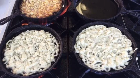 Close up, funnel cakes cooking Stock Footage 73778144
