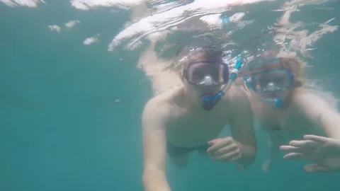 Close-up of funny and happy man and woman swimming underwater wearing a masks Video stock 85801967