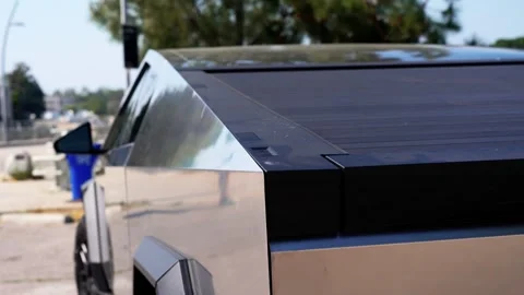 Close-up of a futuristic electric car with an angular design displayed outdoors. Stock Footage 274452457