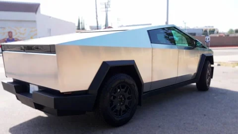 Close-up of a futuristic electric car with an angular design displayed outdoors. Stock Footage 274452613