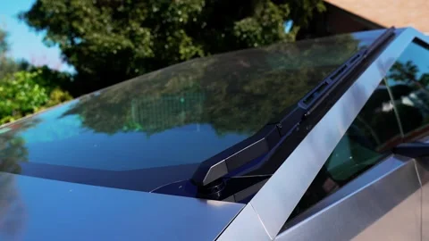 Close-up of a futuristic electric car with an angular design displayed outdoors. Stock Footage 274452698