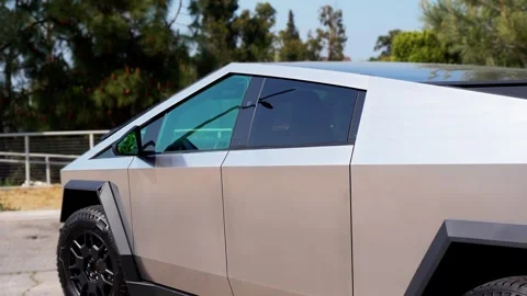 Close-up of a futuristic electric car with an angular design displayed outdoors. Stock Footage 274452888