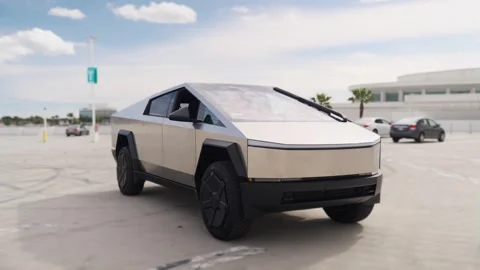 Close-up of a futuristic electric car with an angular design displayed outdoors. Stock Footage 274452996