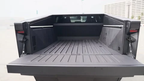 Close-up of a futuristic electric car with an angular design displayed outdoors. Stock Footage 274453027