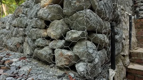 Close-up of a gabion retaining wall filled with natural stones Stock Footage 337976809