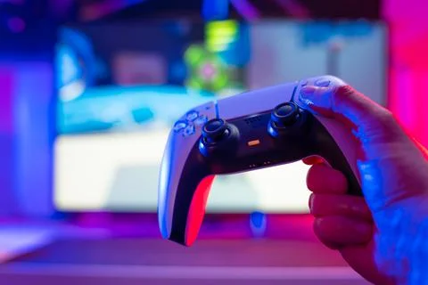 Close-up. Gamepad on a technological background in the hands of a gamer girl. Stock Photos