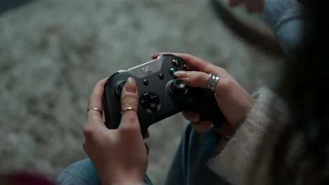 Close-up of the gamepad while playing the girl Stock Footage 168581777
