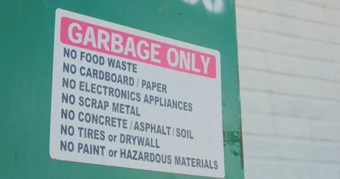 Close up of garbage only sign with prohibited waste list on bin Stock Footage 332249180