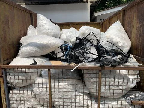 Close up of a  garbage sacks in a large iron basket Stock Photos