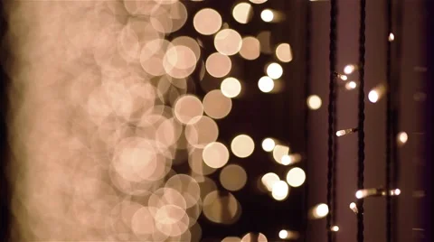 Close up of garland lightbulbs. Bokeh effect. Camera slowly going up. Stock Footage 62529414