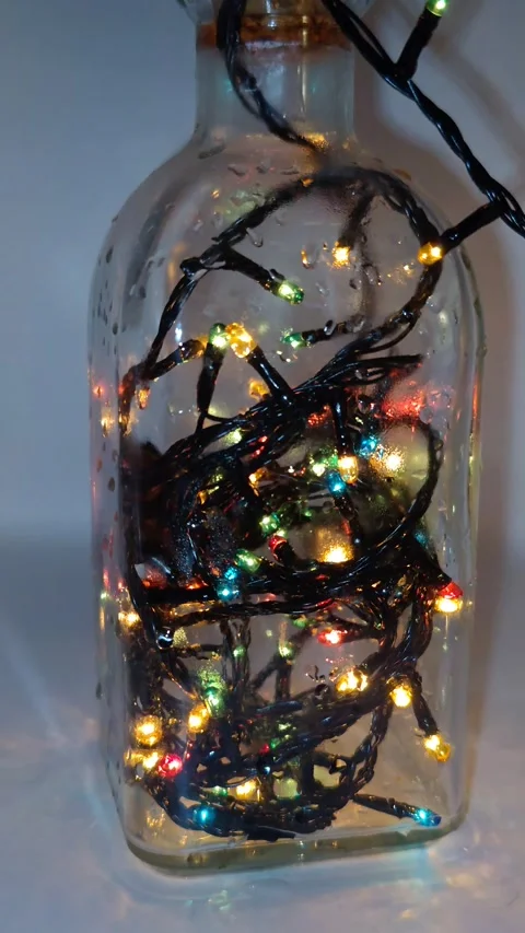 A close-up of a garland of lights in a bottle Stock Footage 323761875