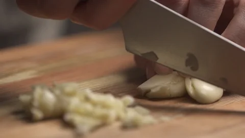 Close up of garlic being chopped Stock Footage 127129269