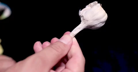 Close-up of garlic spinning on a black background Stock Footage 267058567