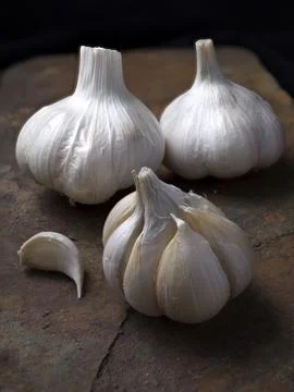 Close up of garlic on a textured surface. Stock Photos