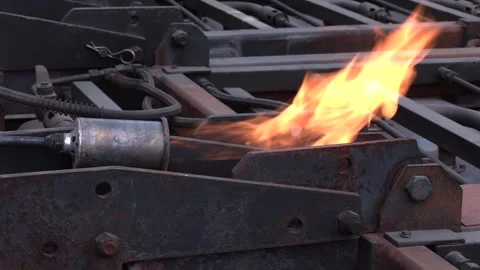 Close-Up of Gas Burner Heating Asphalt Reinforcement Mesh Video stock 344329369