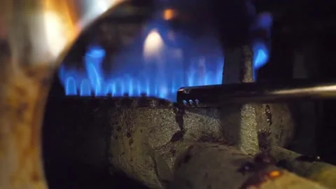 Close-Up of Gas Burner Igniting with Blue and Orange Flames Video stock 343027126
