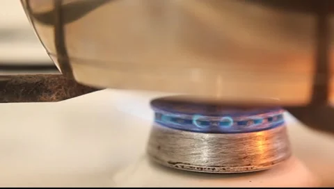 Close-up of a gas cooker with pot Stock Footage 7754377