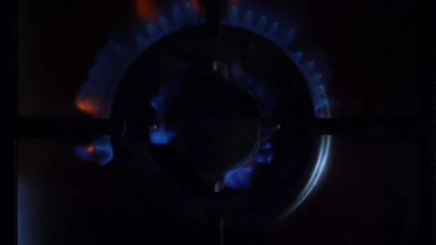 A close-up of a gas cooking ring being lit. Stock Footage 130476145