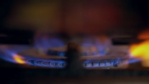 A close-up of a gas cooking ring being lit. Stock Footage 130479252