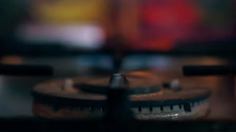 A close-up of a gas cooking ring being lit. Stock Footage 130479577