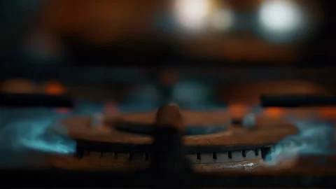 A close-up of a gas cooking ring being lit. Stock Footage 130479943