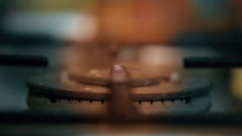 A close-up of a gas cooking ring being lit. Stock Footage 130482223