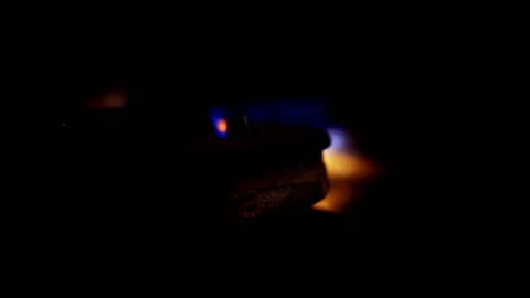 A close-up of a gas cooking ring being lit. Stock Footage 130482277
