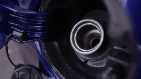 Close up of gas pump going into car petrol intake on gas tank Stock Footage 75487957