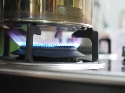 Close up gas stove heating kettle in the kitchen Stock Footage