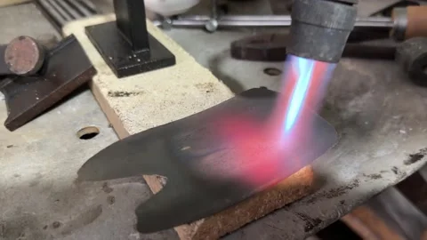 Close-up of a gas torch flame heating a metal plate Stock Footage 327214829