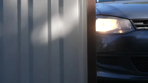 Close-up gate is closed by remote control before entering courtyard of the house Stock Footage 267718312