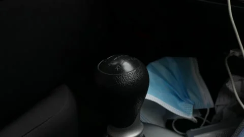 Close-up of a gear lever with a mask facing the background Stock Footage 158768959