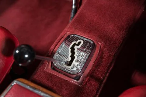 Close up of a gear stick in an automatic classic car interior with a red carp Stock Photos