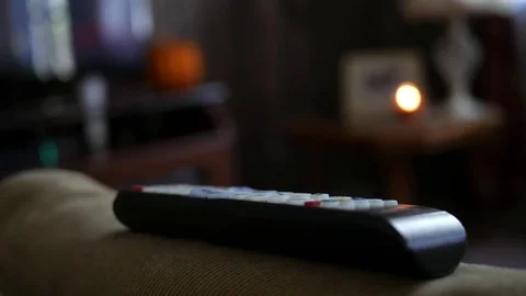 Close up of generic remote control on living room sofa couch Stock Footage 81189759